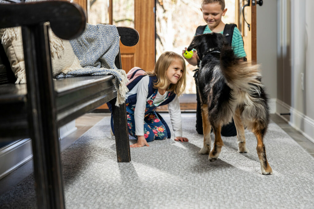 Kids playing with pet | Ambassador Mid-West Floors